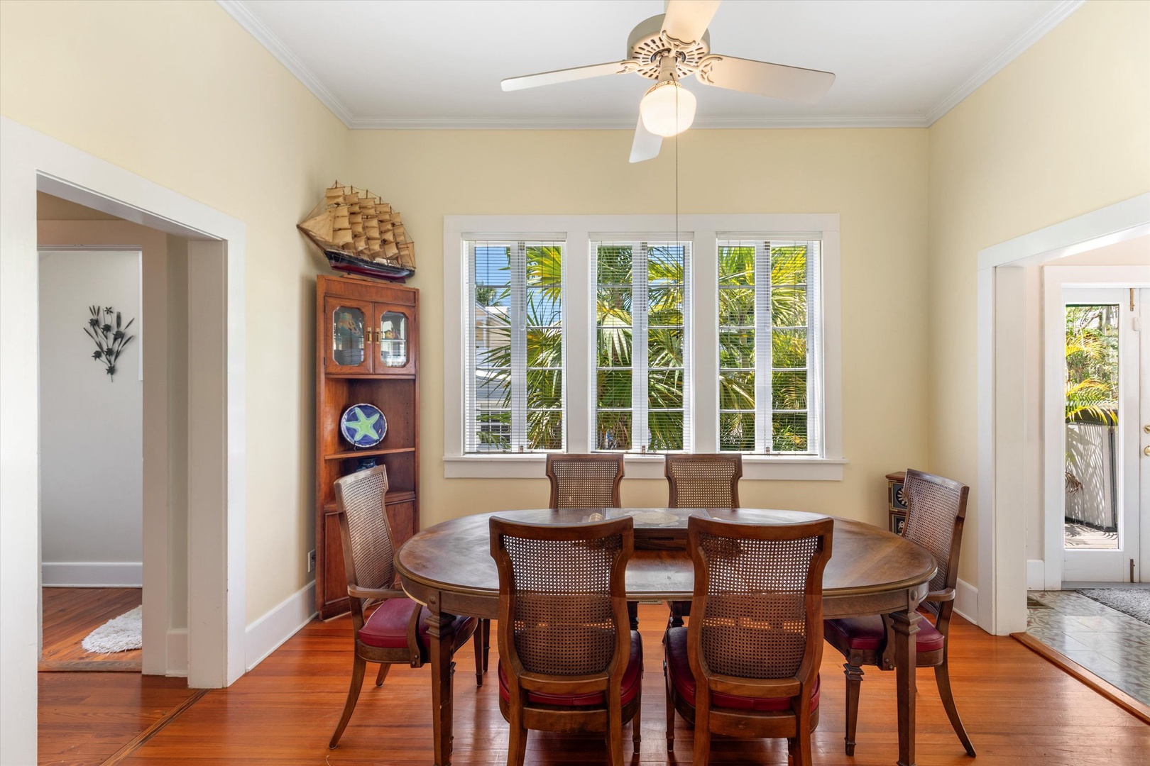 Gather around the elegant dining table where warm wood tones and natural light create the perfect setting for memorable meals together.