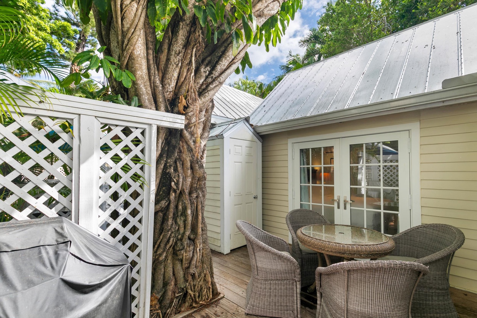 Step onto your private outdoor seating area, shaded by lush tropical foliage and furnished with cozy wicker chairs—perfect for sipping morning coffee or unwinding after a day of adventure.