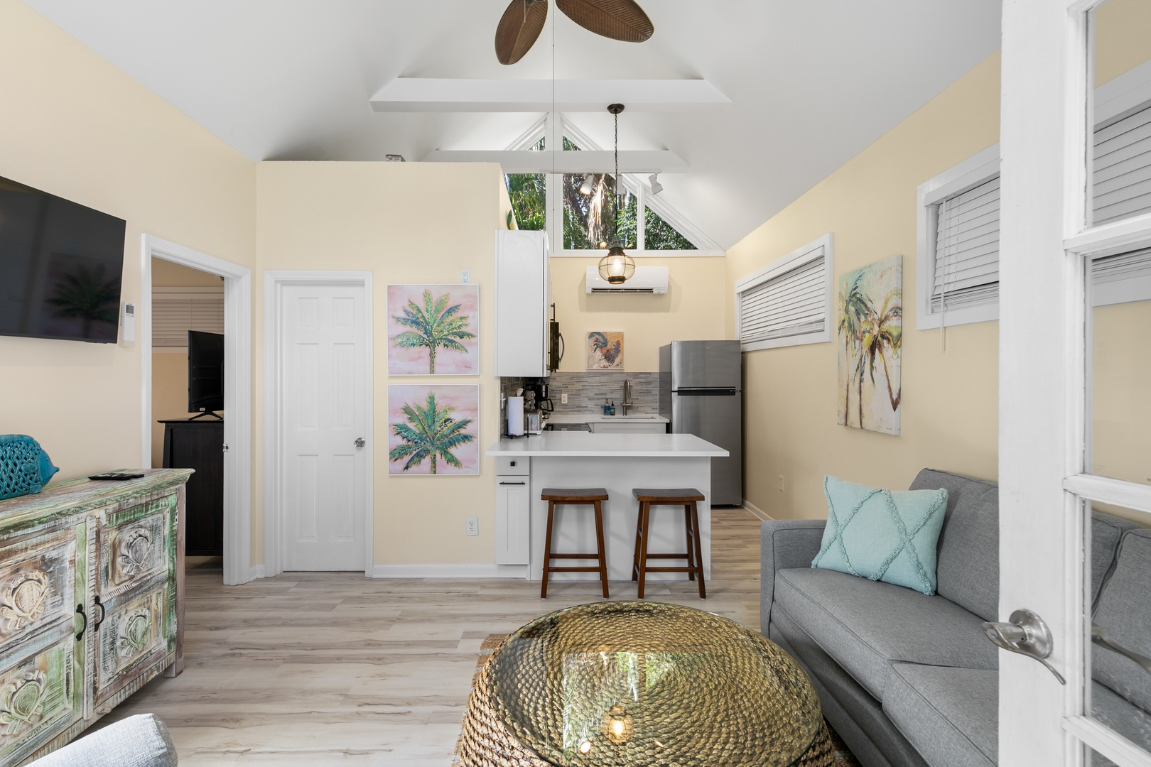 Step into your bright, airy retreat where tropical breezes meet coastal charm. The open layout invites you to unwind on the comfy sofa or enjoy a meal at the kitchen bar, with everything you need close at hand.