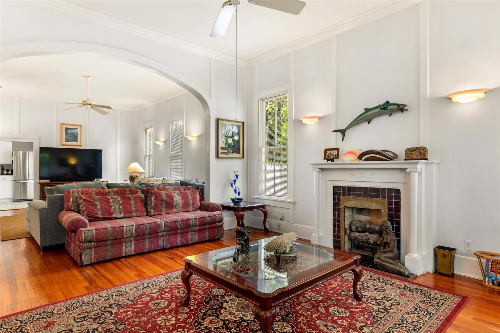 Step into your welcoming living space with soaring ceilings, gleaming hardwood floors, and a cozy fireplace that invites you to unwind after a day of coastal adventures.