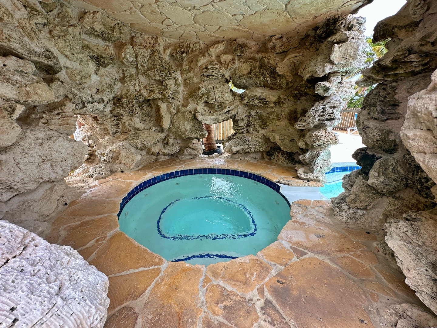 Slip into your own grotto-style hot tub carved into natural stone—a secluded sanctuary where warm water and ancient rock create your private escape.