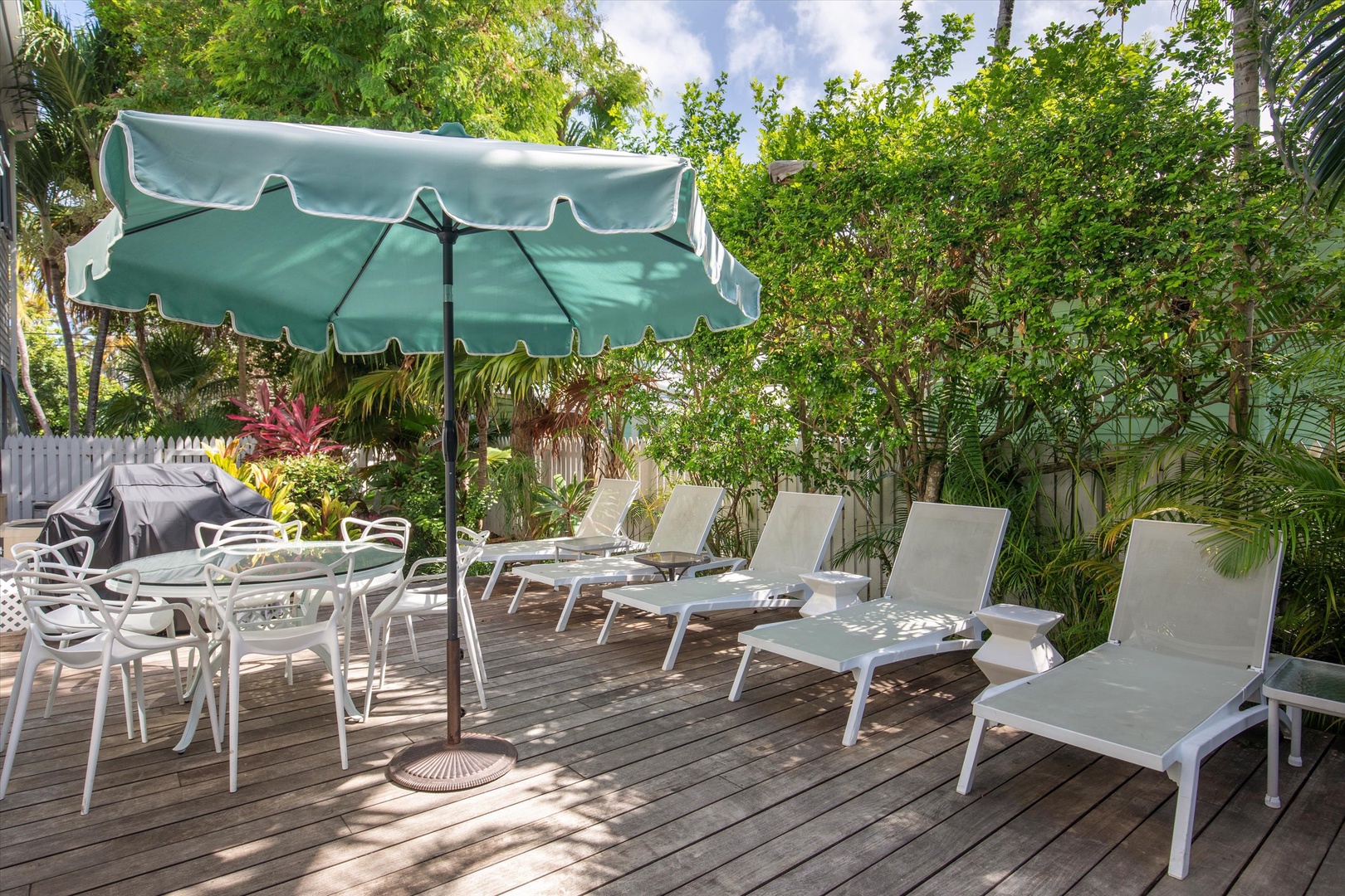 Pool deck with lounge chairs and outside dining area