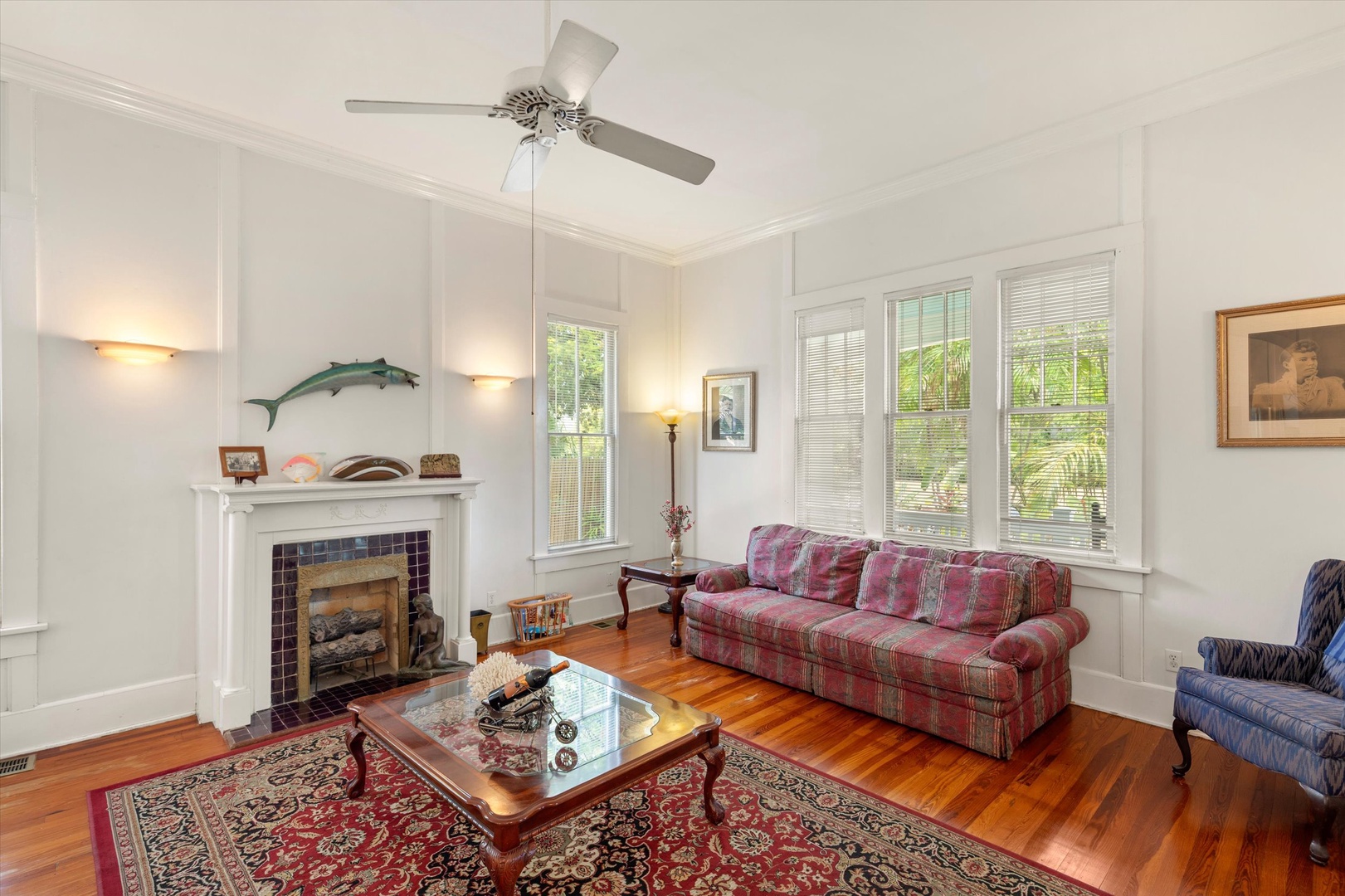 Sink into the plush sofa and feel the tropical breeze through large windows. The fireplace adds warmth while ceiling fan keeps you cool—your perfect retreat.