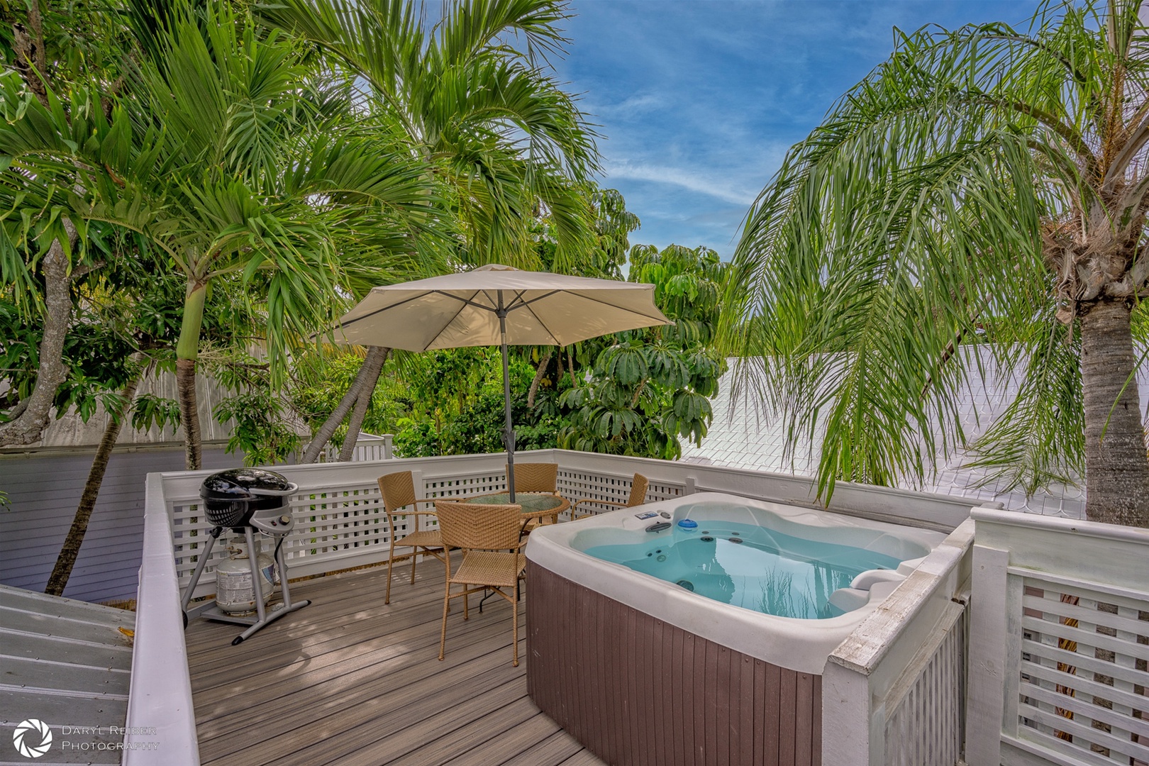 Private rooftop deck with hot tub, seating area and grill