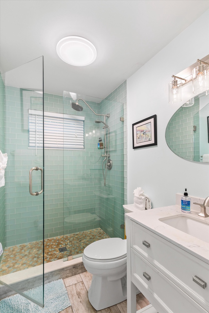 Refresh in your spa-like bathroom with soothing sea-glass tiles, a spacious walk-in shower, and bright coastal charm throughout.