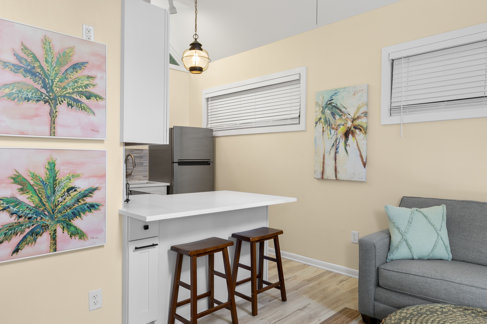 Settle into your bright open-concept space where warm coastal tones, a sunny kitchen island, and beachy artwork invite you to unwind and feel at home from the moment you arrive.