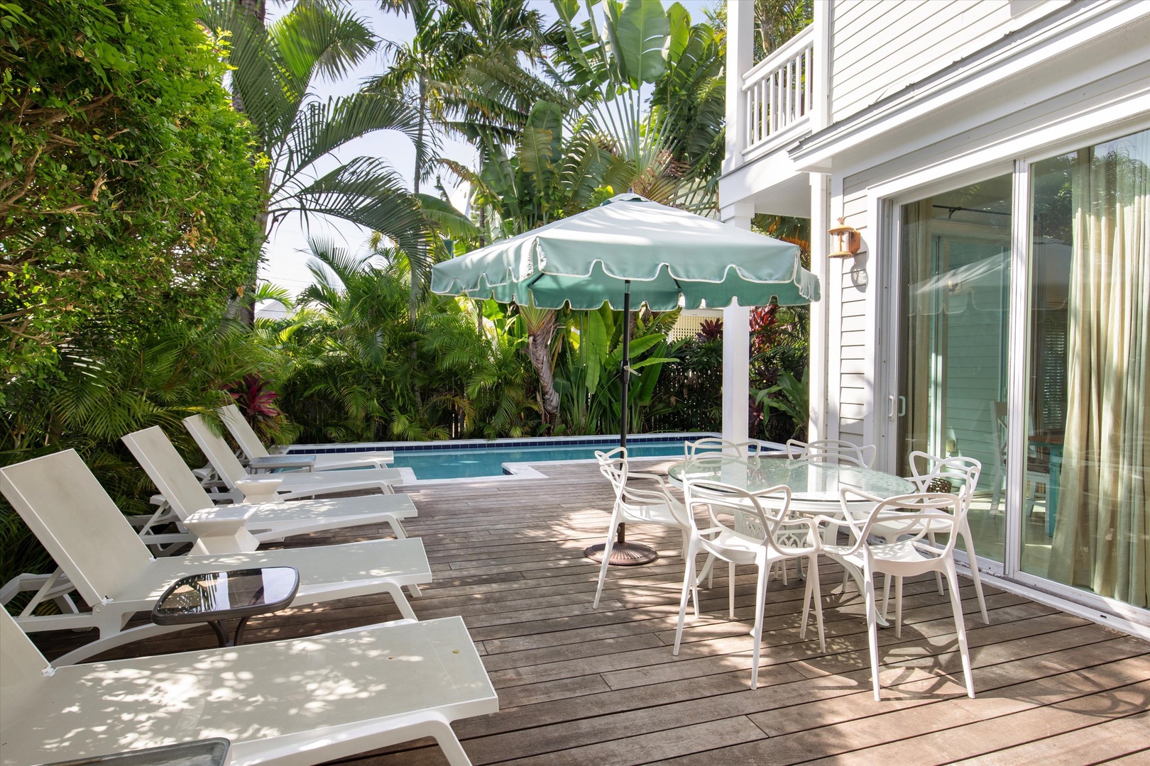 Pool deck with lounge chairs and outside dining area