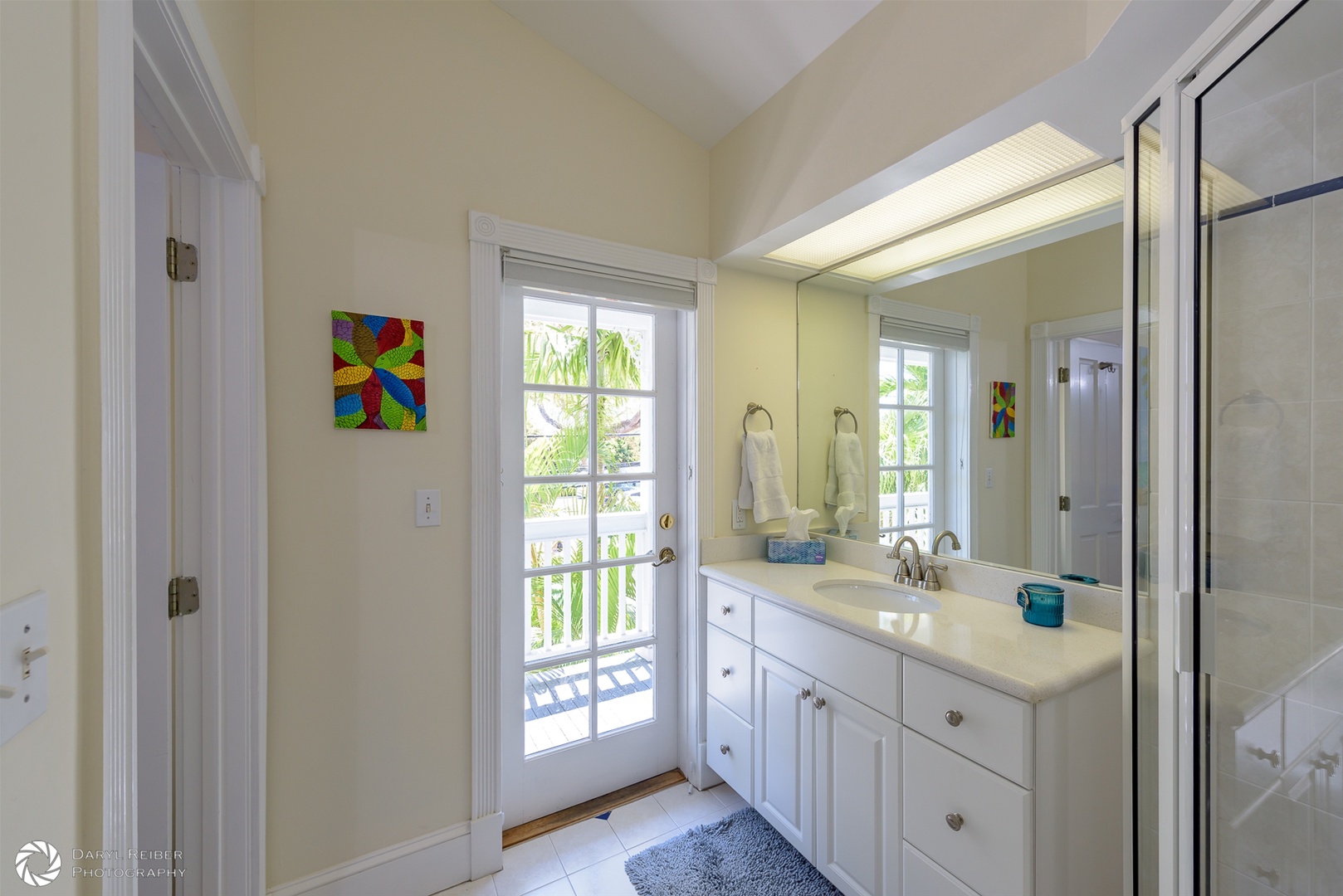 2nd Bedroom ensuite full bathroom with door to covered balcony with seating