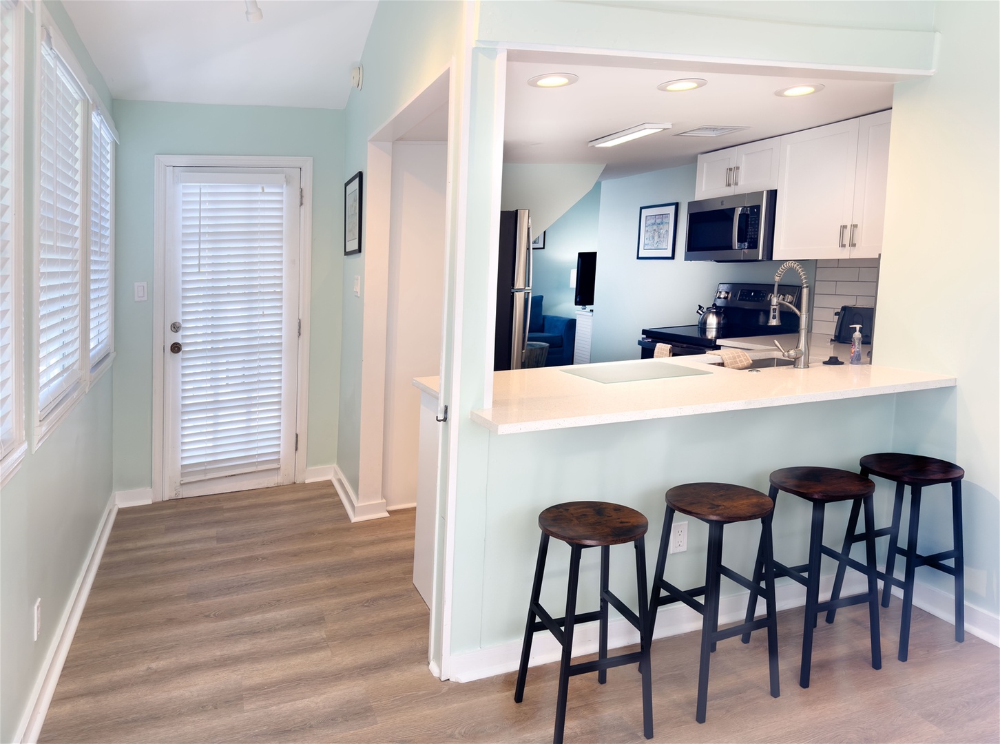 Kitchen area with breakfast bar and back door that leads to side deck