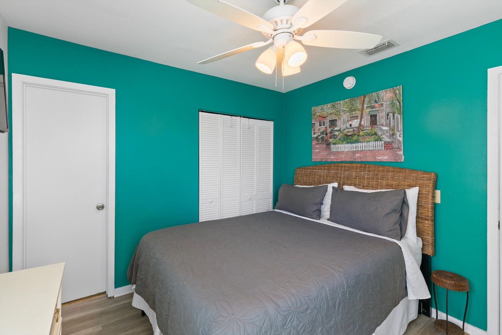 Slip into crisp linens under the gentle breeze of your ceiling fan in this vibrant bedroom. Ample storage and charming coastal touches make it easy to settle in for a restful night.