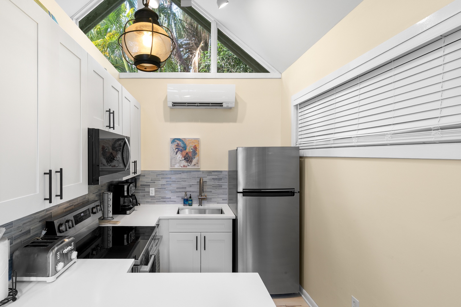 Cook your meals in this stylish, fully-equipped kitchen filled with natural light from the skylight above. Modern appliances and sleek countertops make preparing food a pleasure.