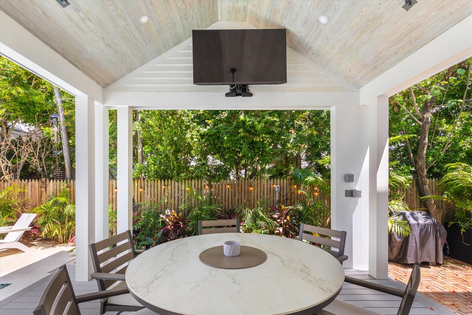 Dine outdoors under a vaulted ceiling with garden views—your own peaceful retreat for morning coffee or evening meals.