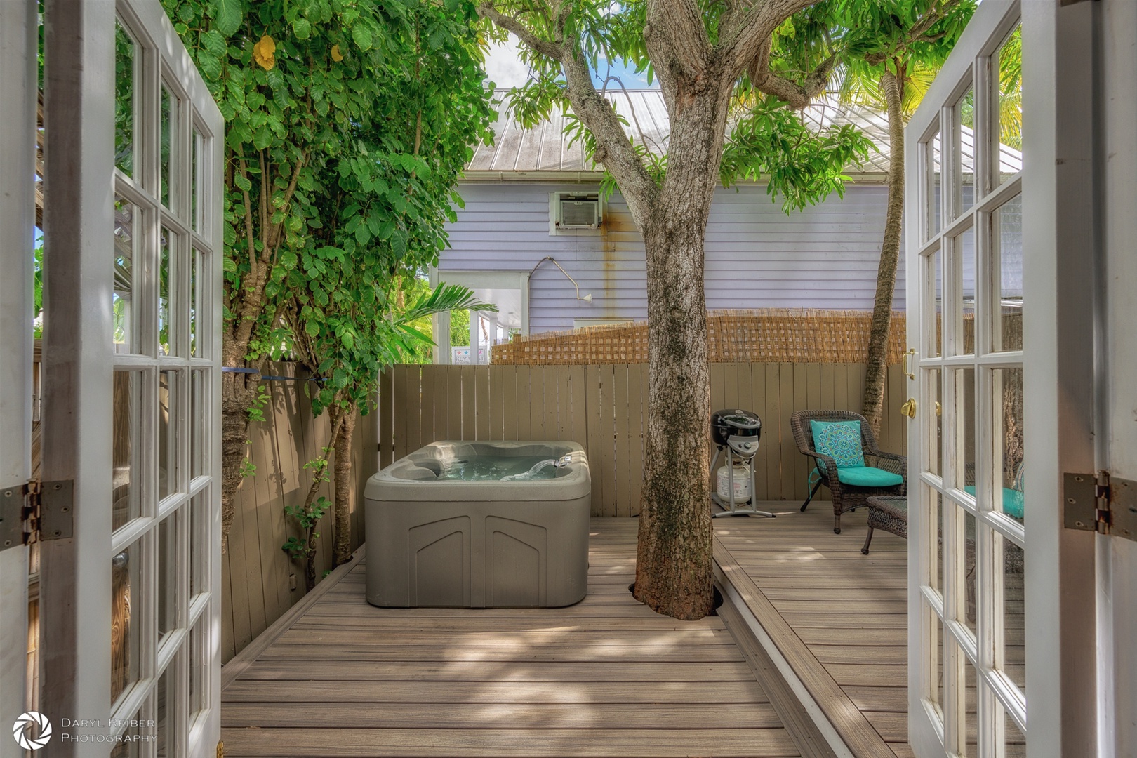 Private deck with hot tub and seating area and grill