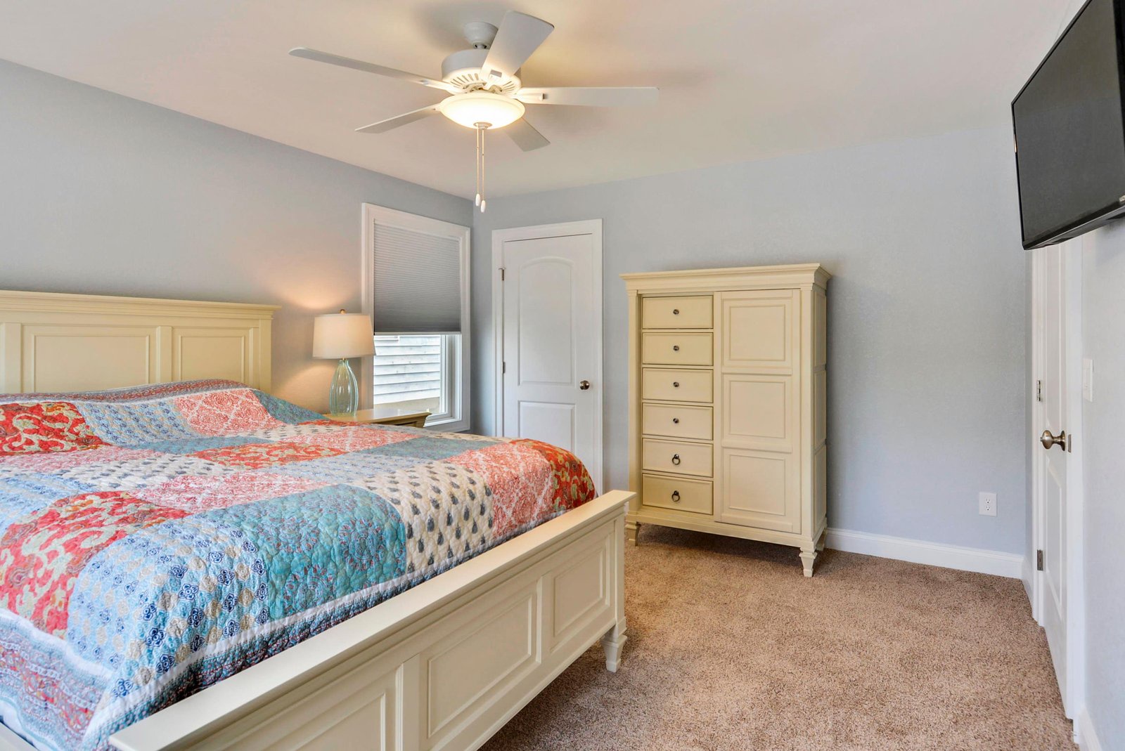 Sink into your cozy bedroom retreat with soothing blue-gray walls and crisp white furnishings that set the tone for restful nights ahead.