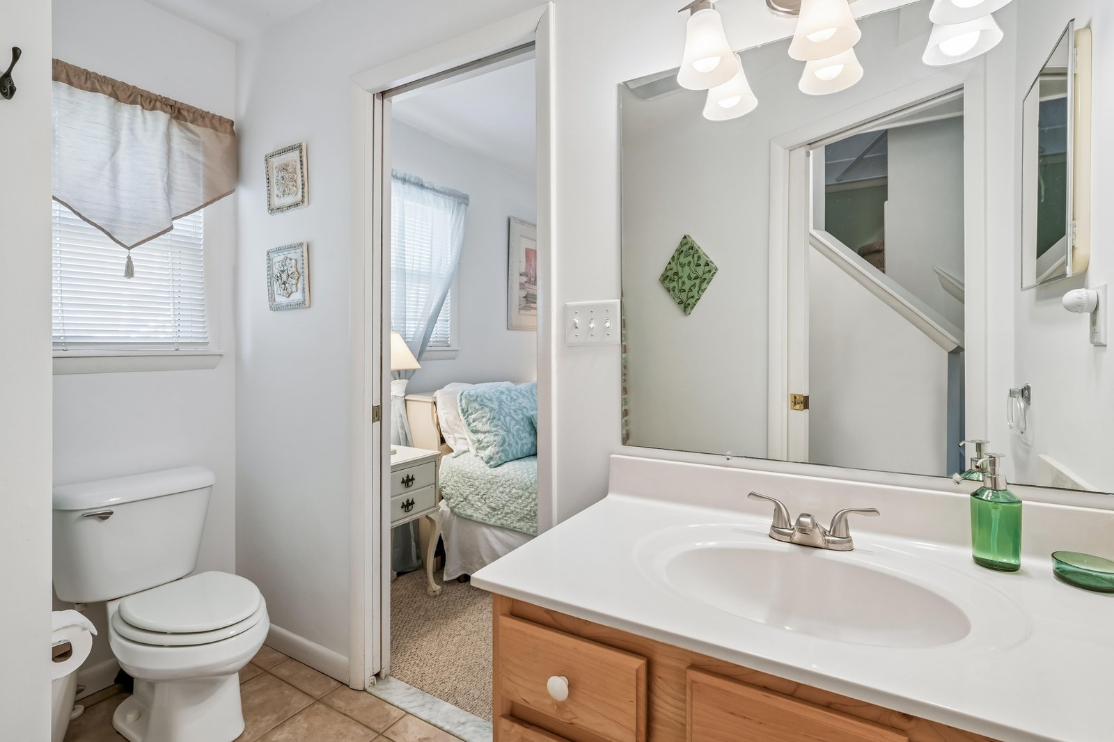 Your private bathroom features a bright vanity, fresh linens, and a cozy bedroom just beyond—everything you need to feel at home during your stay.