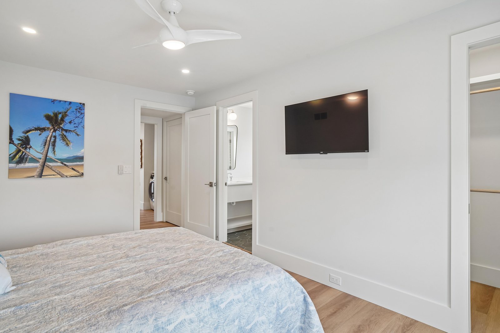 Sink into the comfort of your bright, airy bedroom, where a ceiling fan keeps things cool and a wall-mounted TV awaits your favorite shows. Relax and unwind in this inviting space designed for restful nights.