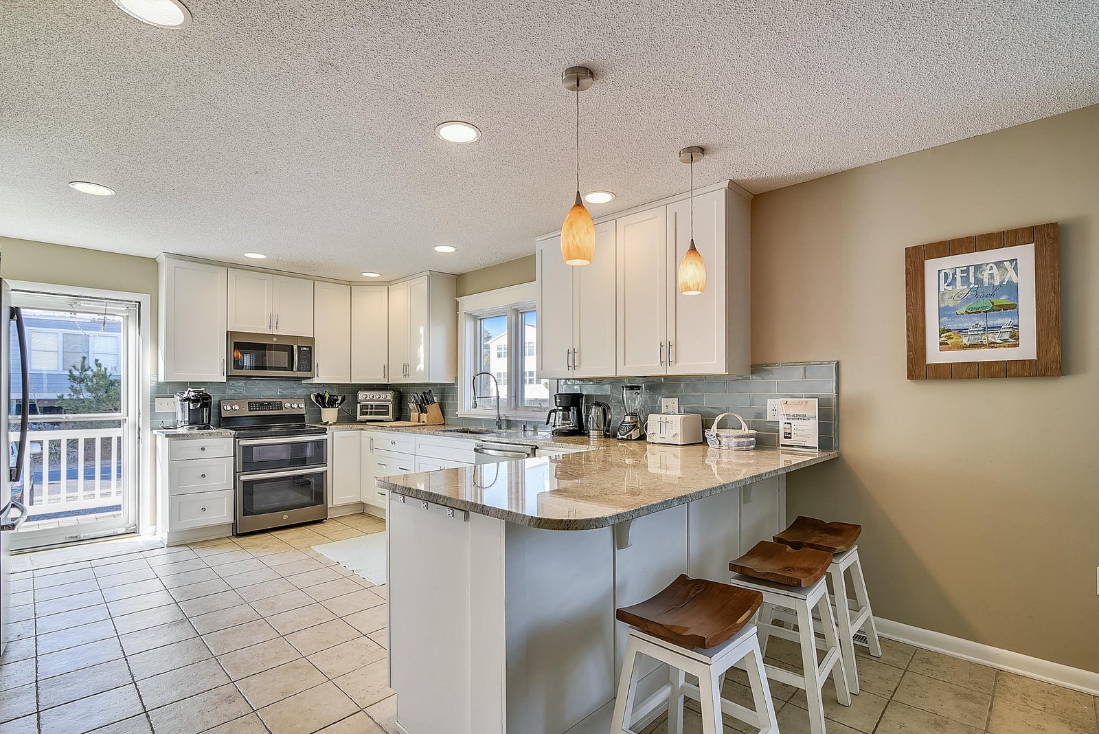 Step into your fully equipped kitchen with everything you need to prepare delicious meals. The granite countertops, modern appliances, and breakfast bar with seating make cooking and gathering a breeze during your coastal getaway.