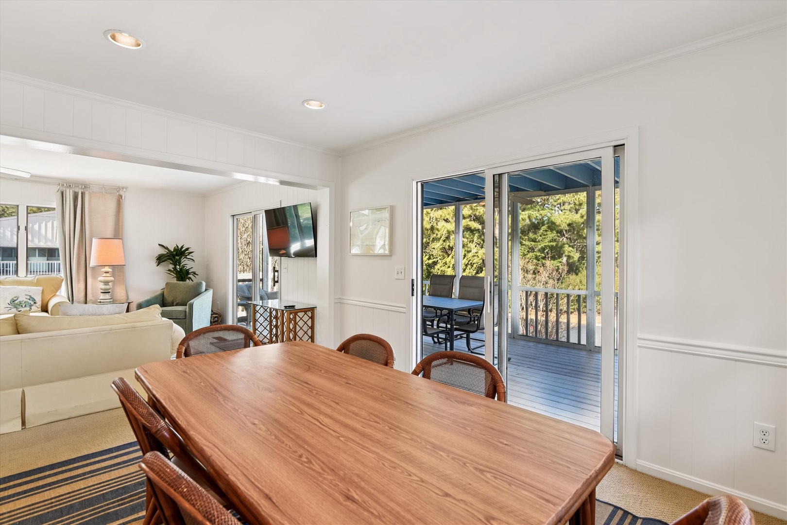 Your dining space flows seamlessly to the covered deck, where you can enjoy meals with beautiful garden views.