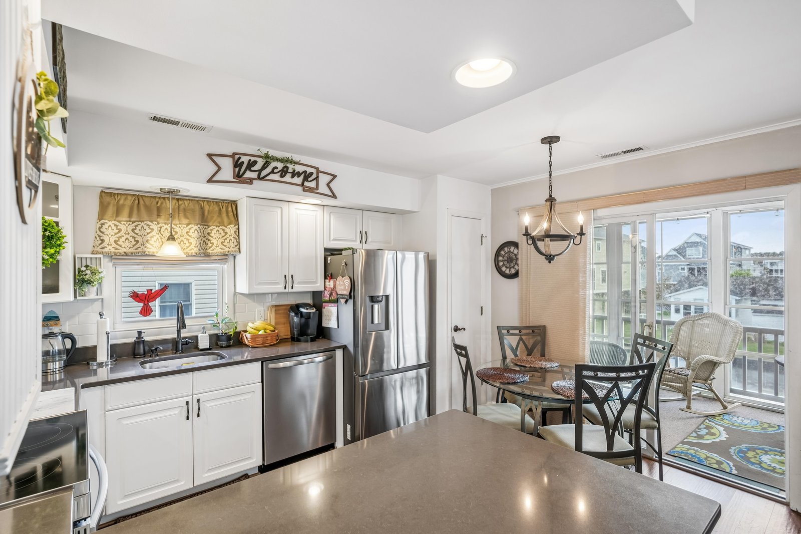 Your bright, fully-equipped kitchen flows into a charming dining nook with coastal views, where morning coffee and homemade meals feel like a true retreat.