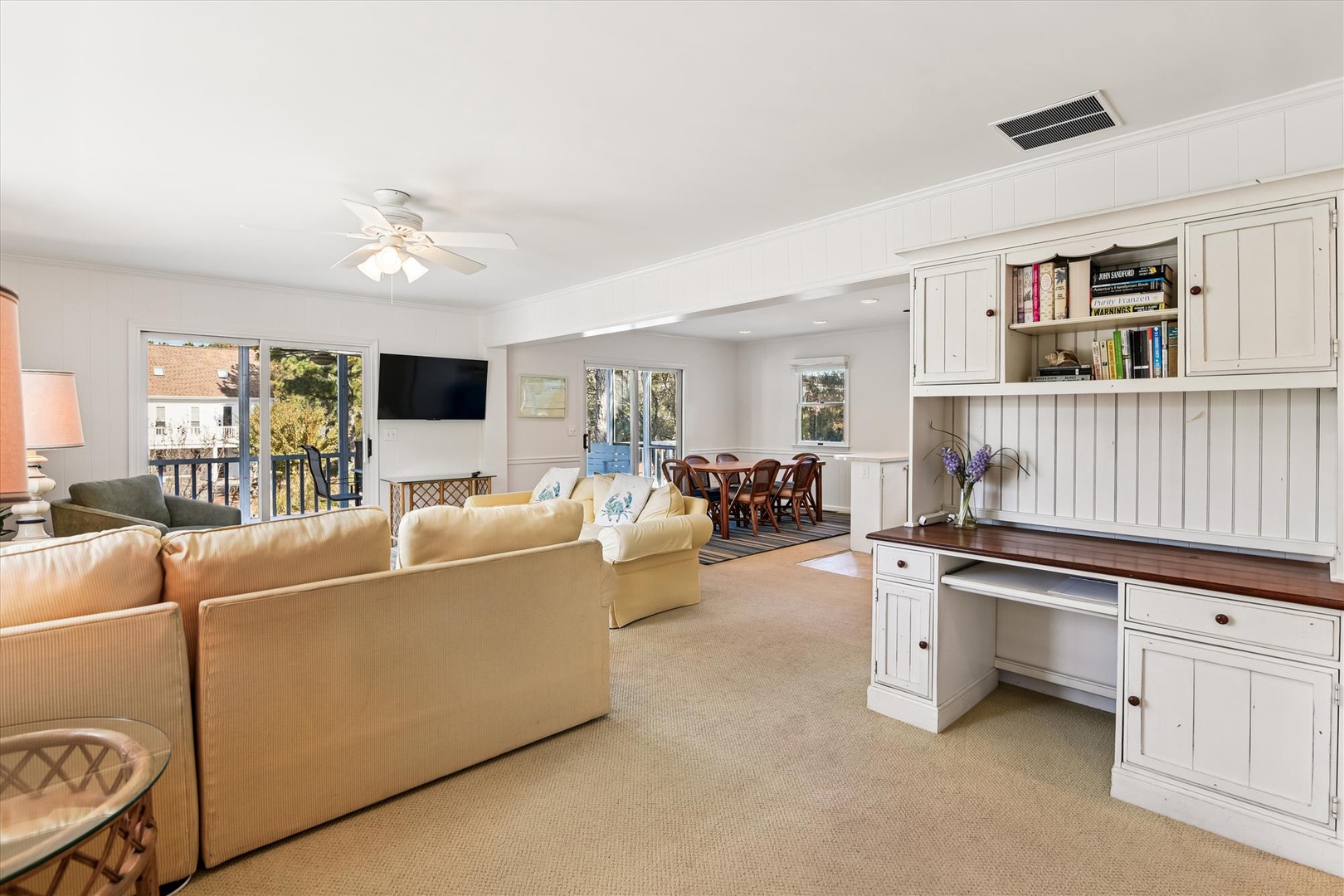 Your spacious living room features built-in workspace, cozy seating, and balcony doors that flood the space with natural light.