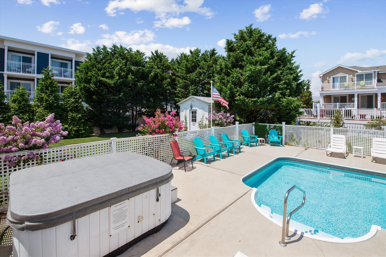 Unwind by your private pool and hot tub, surrounded by vibrant flowering gardens and turquoise lounge chairs perfect for soaking up sunny afternoons.