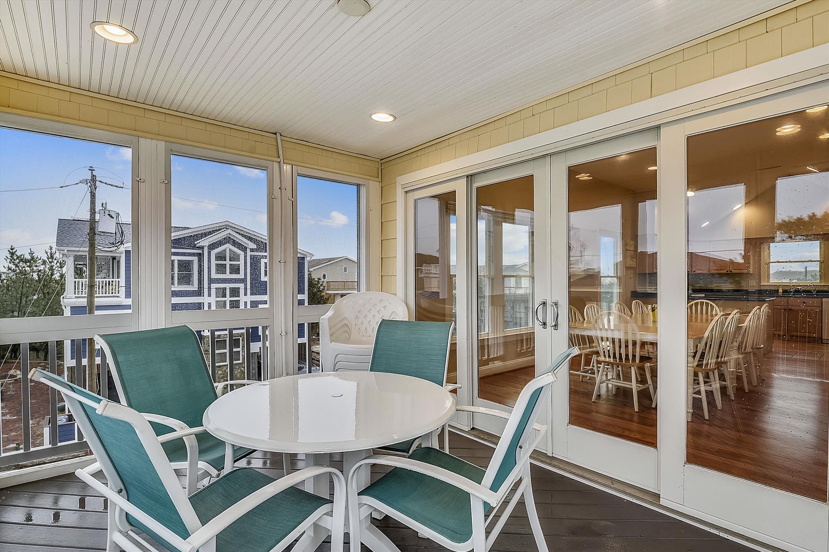 Step onto your private balcony and unwind at the cozy outdoor table, where coastal breezes meet bright skies. Glass doors connect you seamlessly to the dining room inside—perfect for morning coffee or evening gatherings.