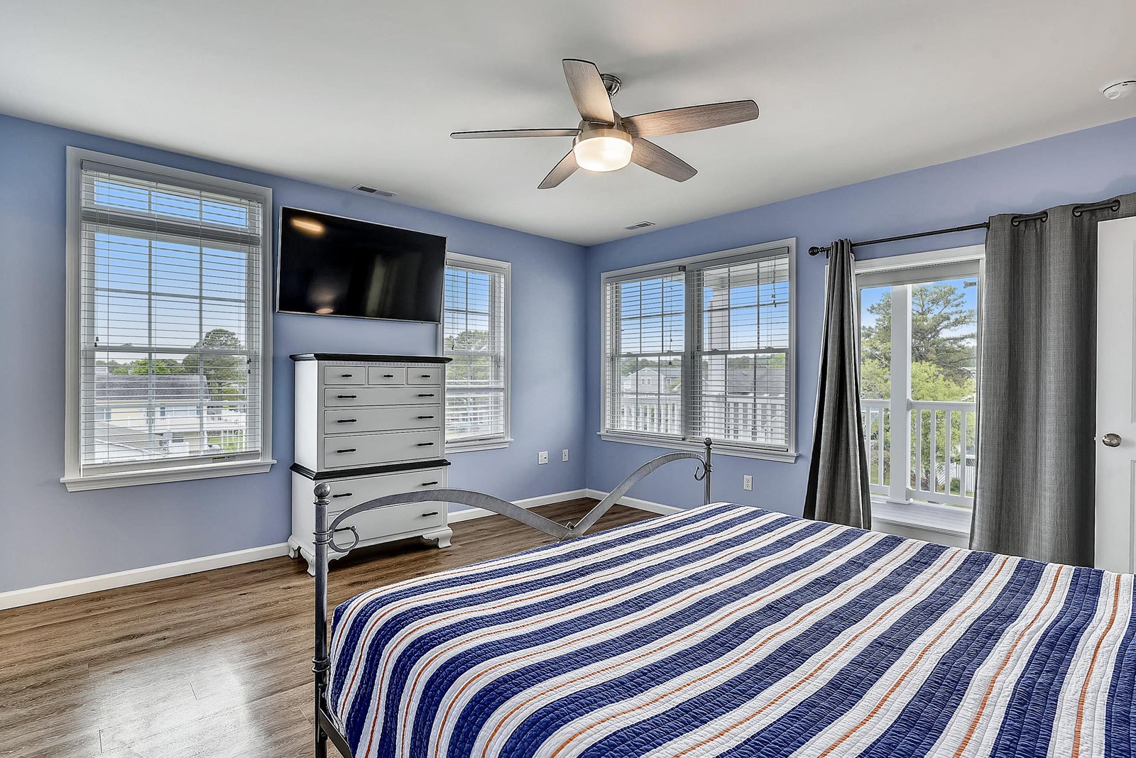 Unwind in your serene coastal retreat, where calming blue tones meet natural light streaming through multiple windows. Step onto your private balcony for fresh air and peaceful moments.