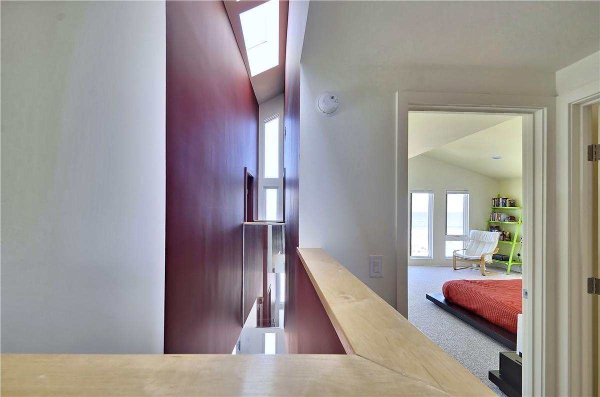 Bright, open hallway connects to your private bedroom suite with modern skylights and sleek finishes throughout.