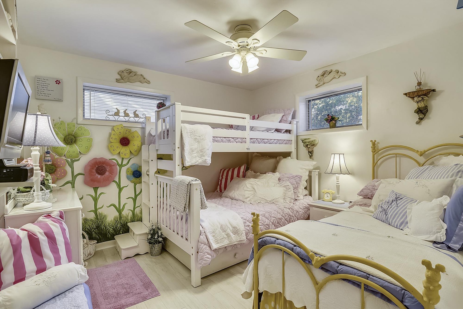 Bright, cheerful bedroom with charming décor and cozy beds where your family can rest after a day of adventure. Whimsical touches like floral wall accents and soft lighting create a warm, inviting space for everyone.