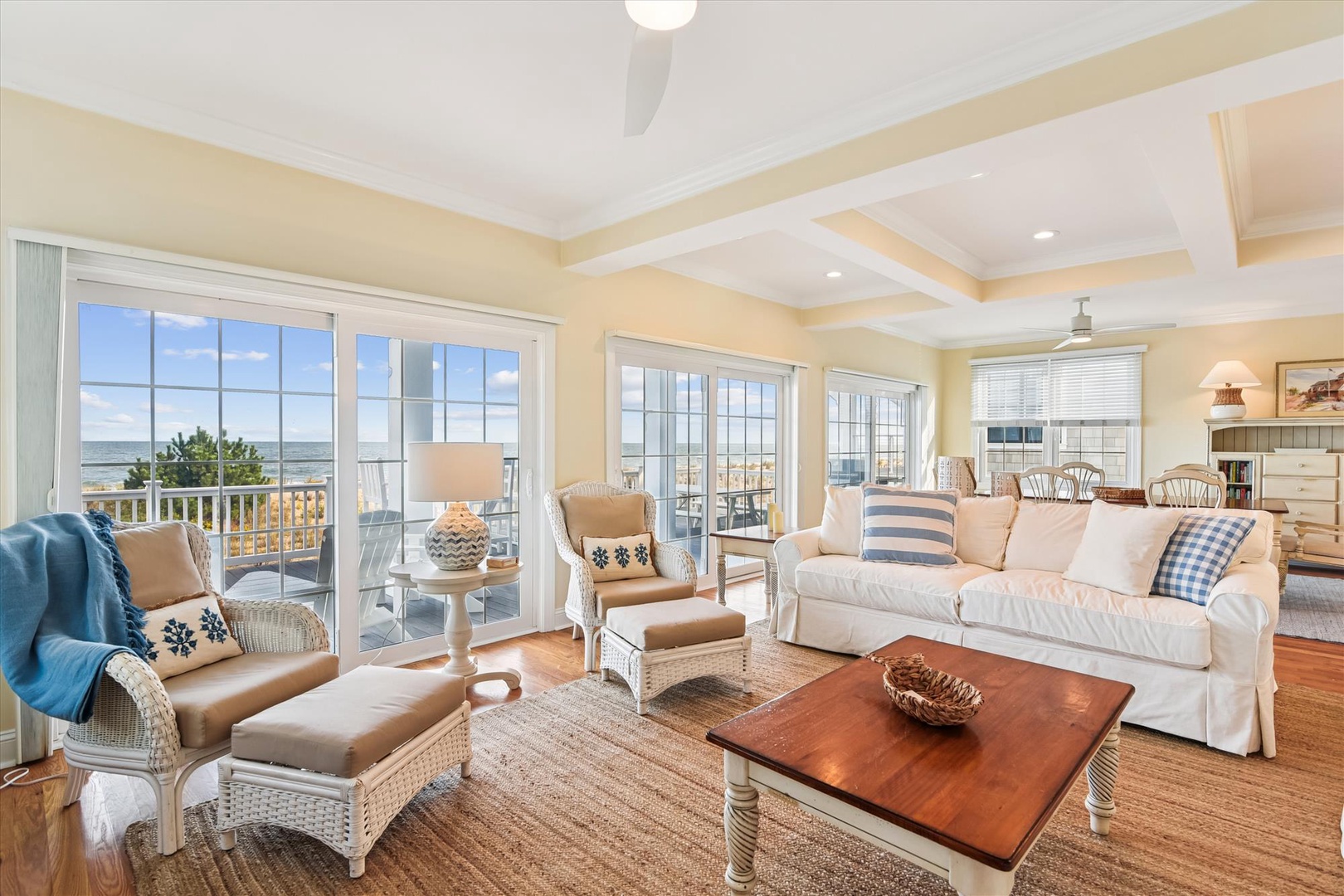 Sink into plush coastal comfort while savoring stunning water views through expansive French doors that flood your living space with natural light and sea breezes.