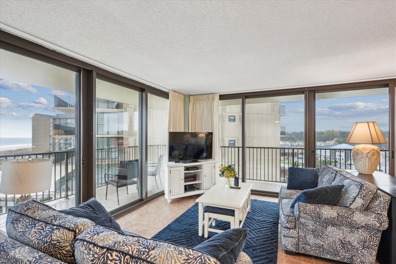 Relax in your coastal living room, where floor-to-ceiling windows frame sweeping water views. Sink into stylish seating, enjoy your favorite shows, and step outside to your private balcony for fresh air.