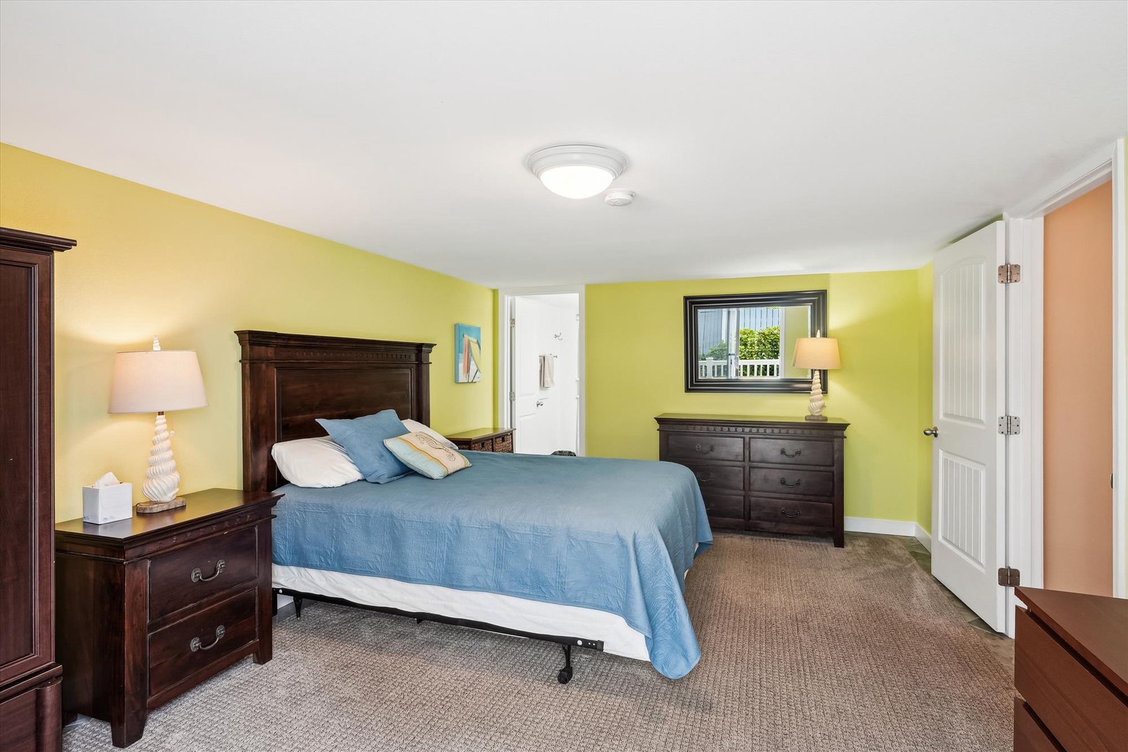 Step into your sunny, serene bedroom featuring a plush bed, warm lighting, and plenty of storage space to unwind and recharge after exploring the local area.