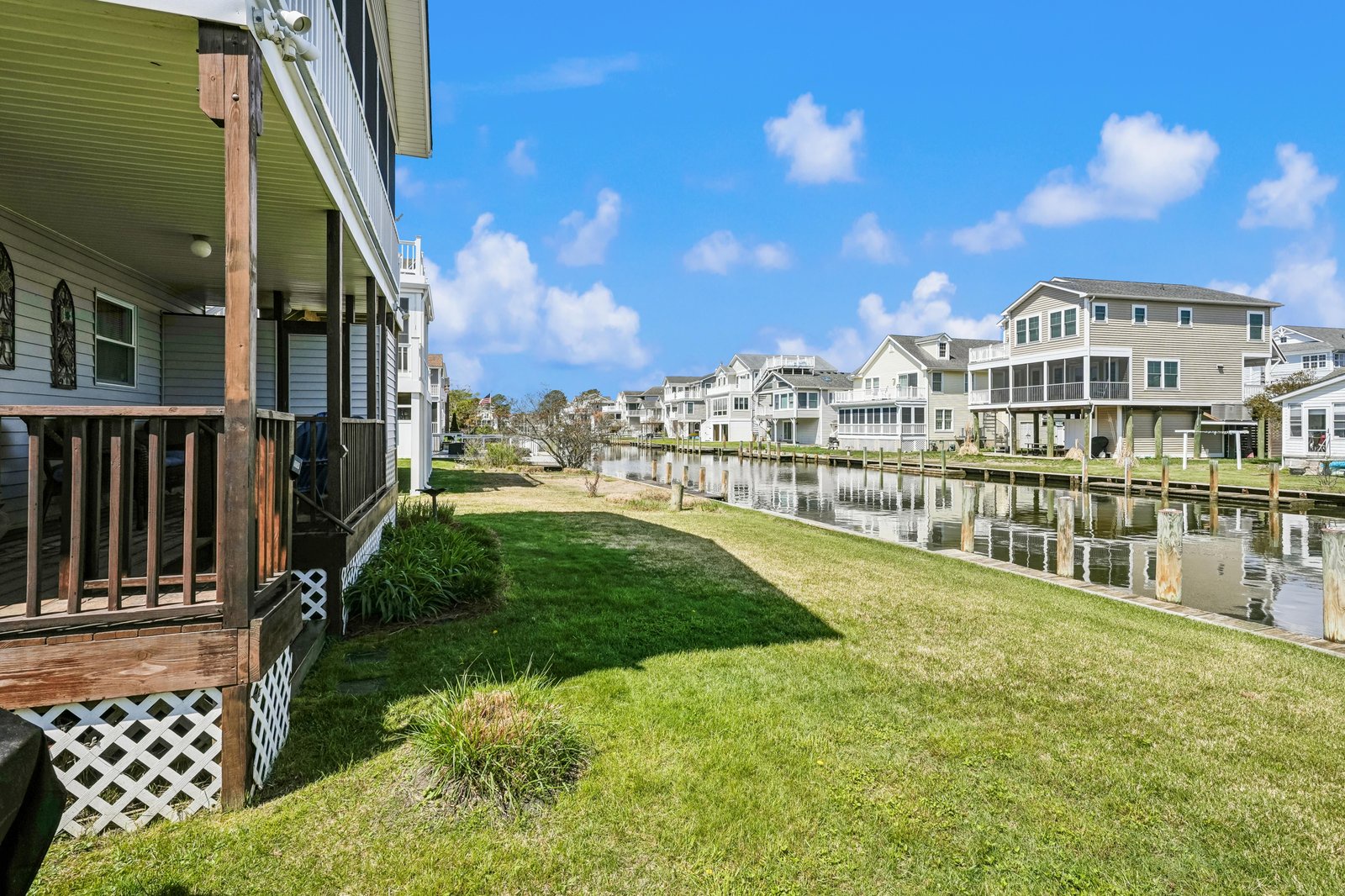 Waterfront community with a private canal, lush lawn, and dock access—perfect for fishing, kayaking, or simply soaking up the coastal calm.