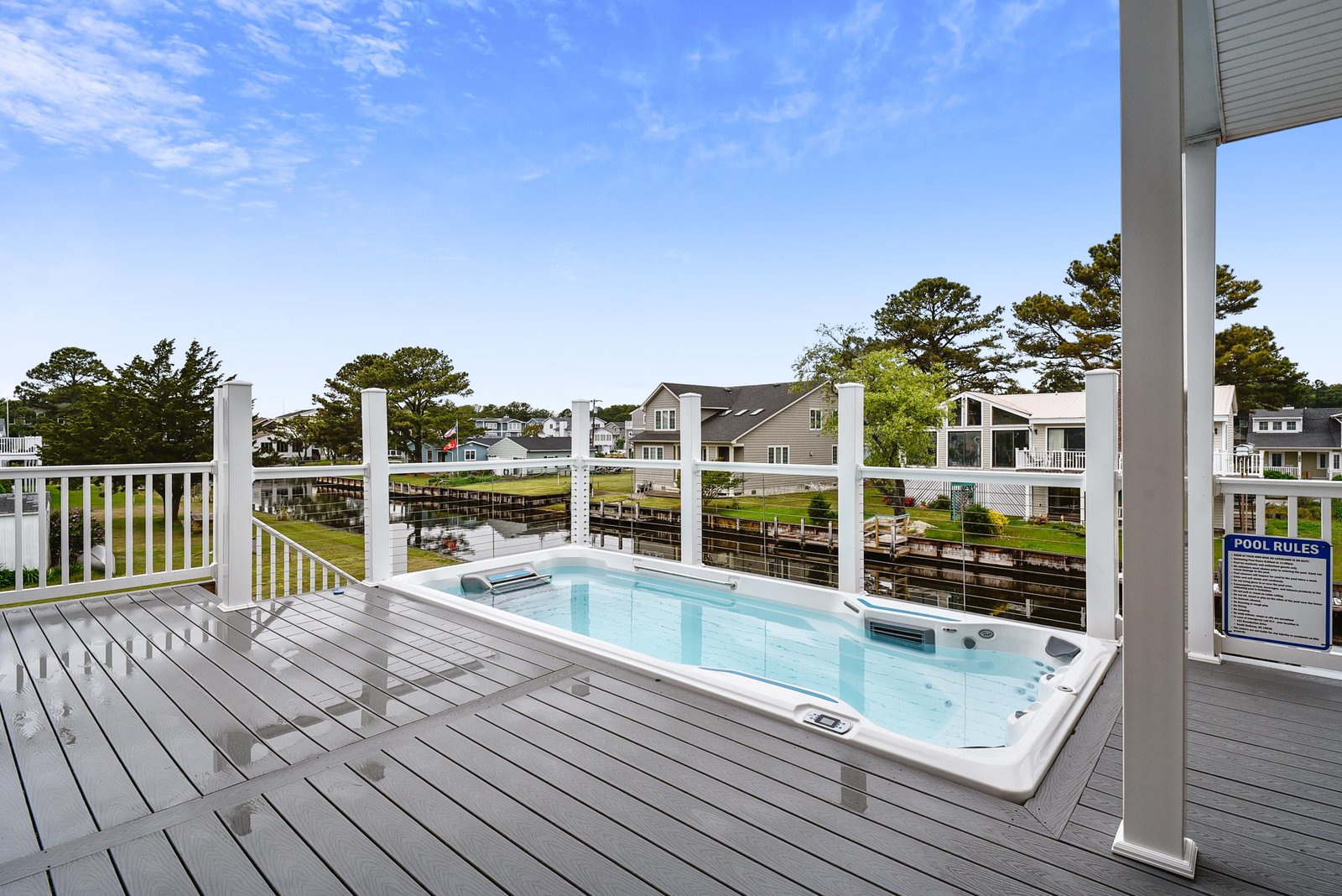 Soak away stress in your private hot tub, set on a spacious deck overlooking tranquil canal-side views and lush green spaces.