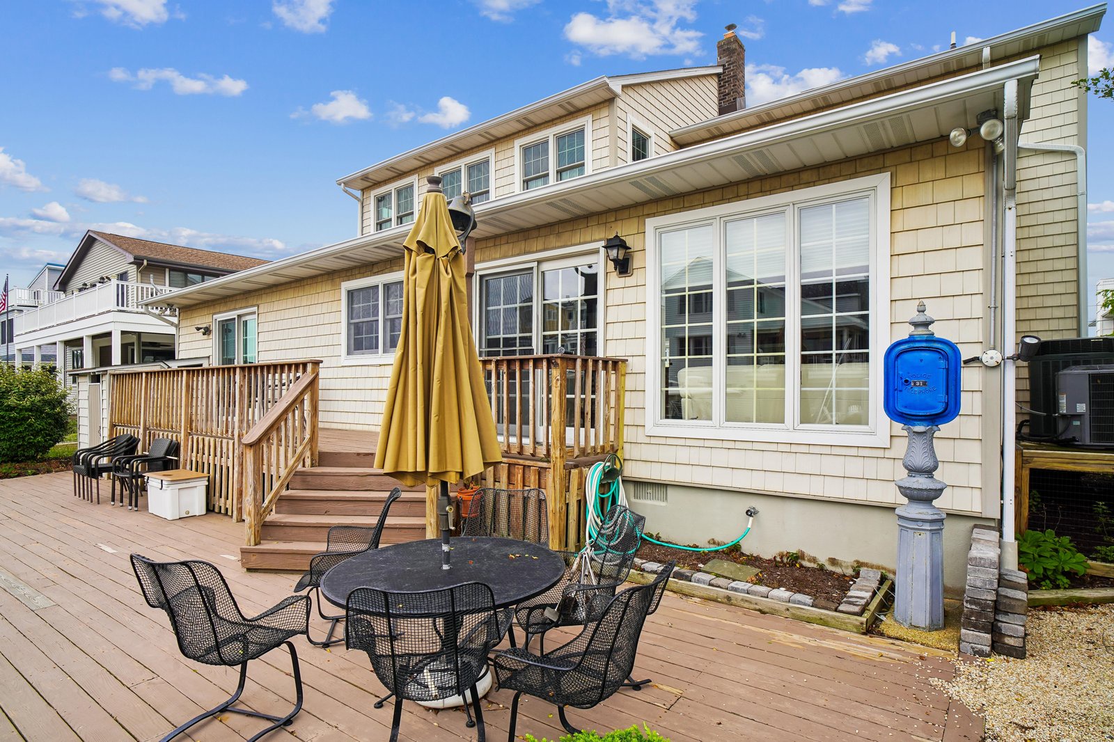 A charming two-story beach house with spacious outdoor decking, perfect for enjoying sunny afternoons and coastal breezes.