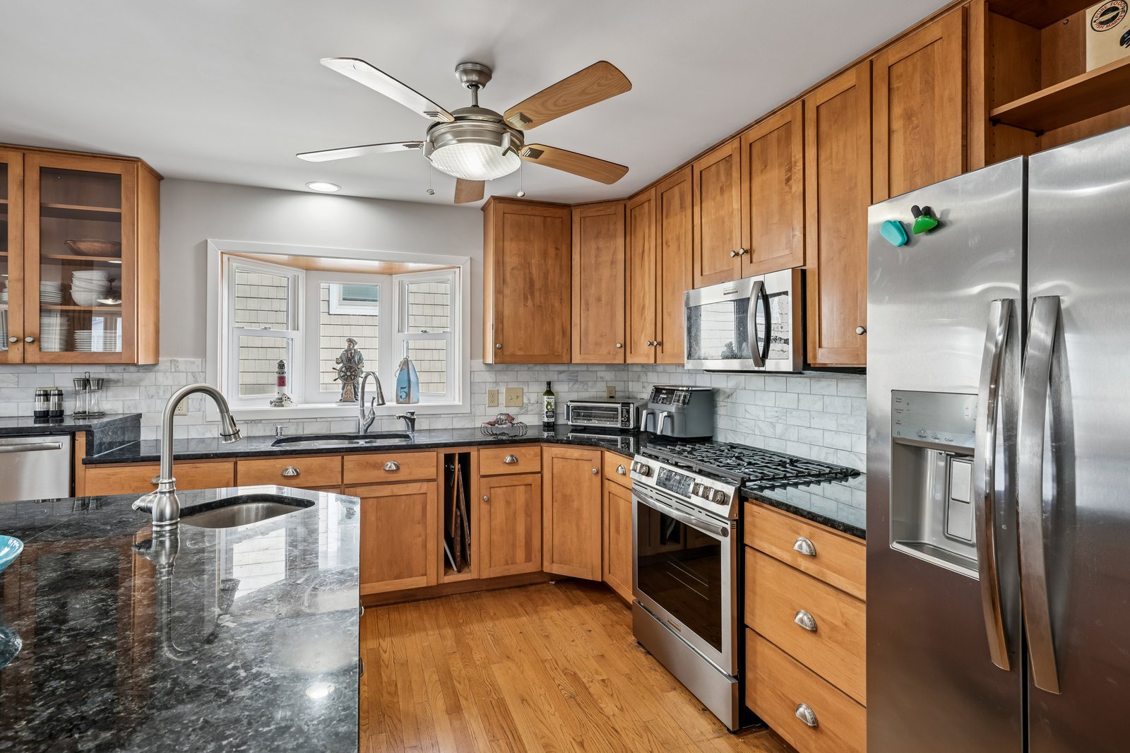 Your fully equipped kitchen features granite counters, stainless appliances, and warm wood cabinets for all your culinary adventures.