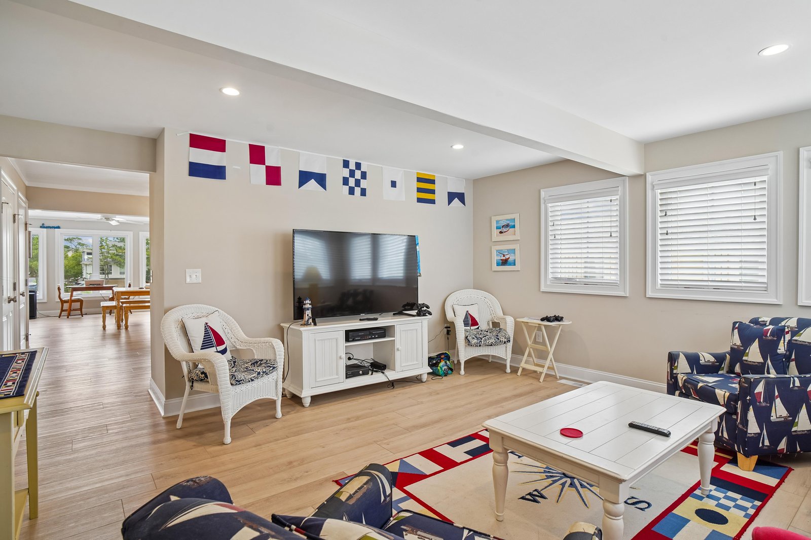Gather in this cheerful nautical-themed living space where coastal charm meets comfort. Bright hardwood floors and playful maritime accents create the perfect setting for relaxing evenings together.