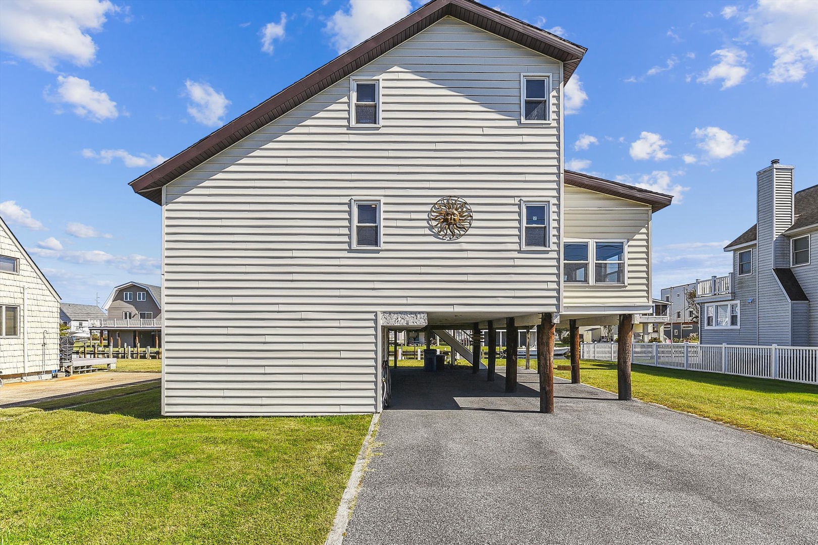 Spacious elevated beach home with ground-level covered parking situated in a quiet coastal neighborhood, offering convenient access to the area's attractions.