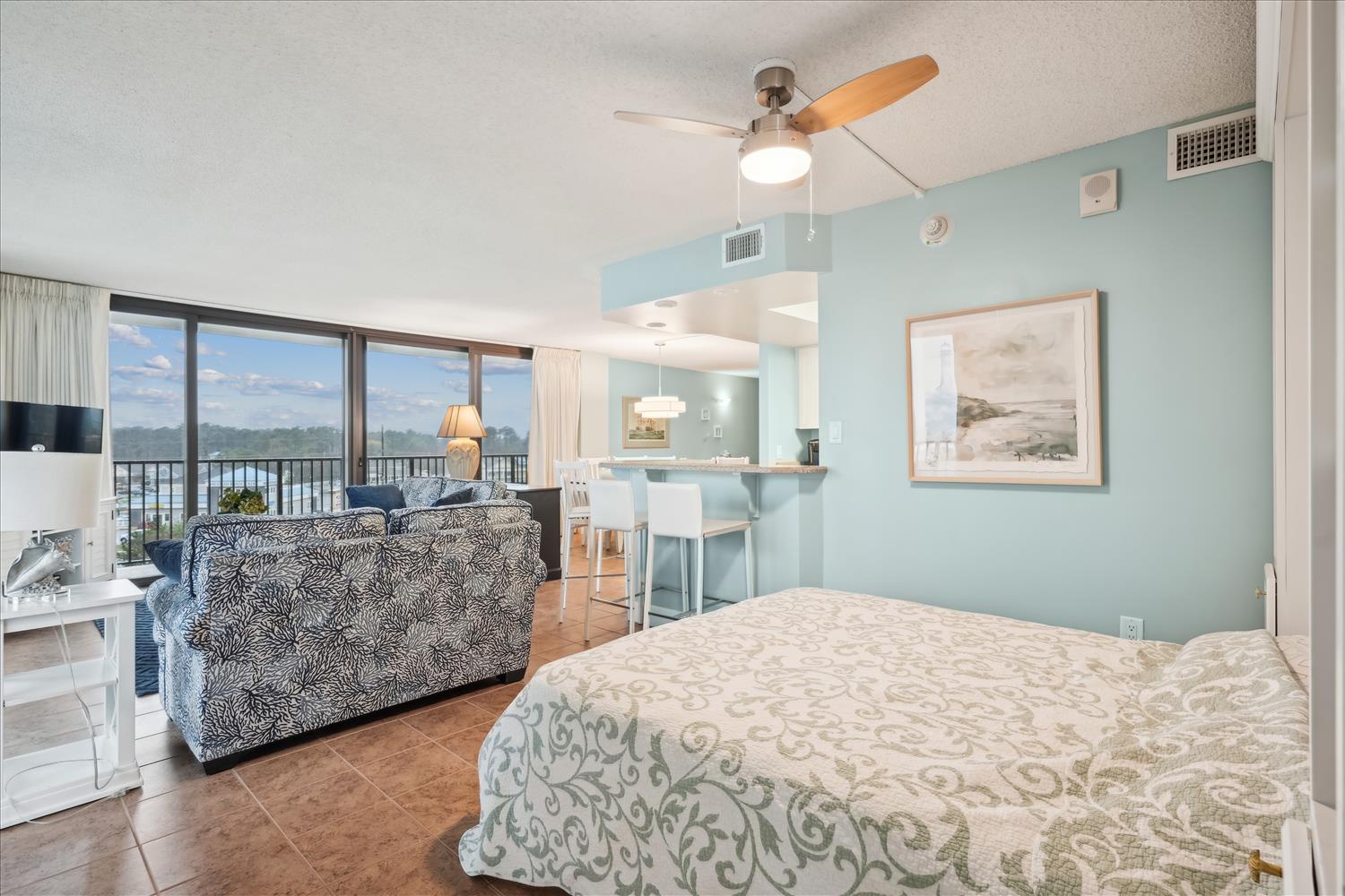 Your bright, breezy waterfront retreat features calming coastal blues, plush bedding, and an open layout where you'll wake to stunning lake views. Relax on the sofa or enjoy meals at the breakfast bar.
