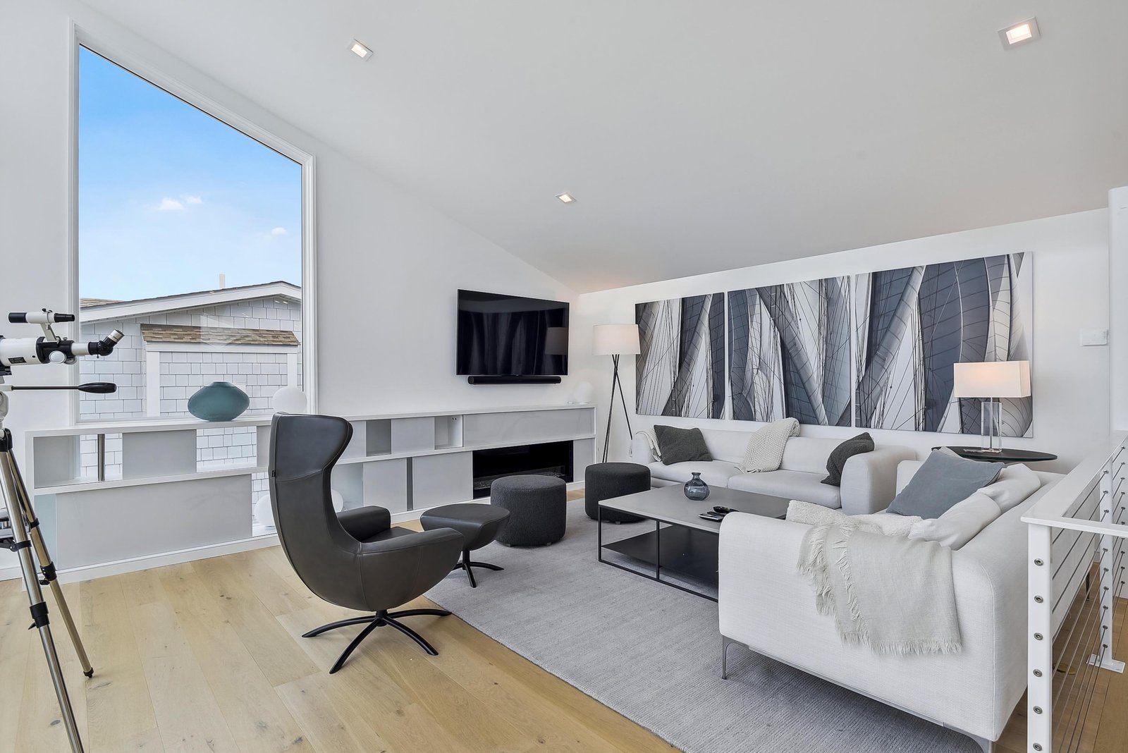 Sink into plush seating and unwind in this bright, modern living room where sleek style meets coastal comfort.
