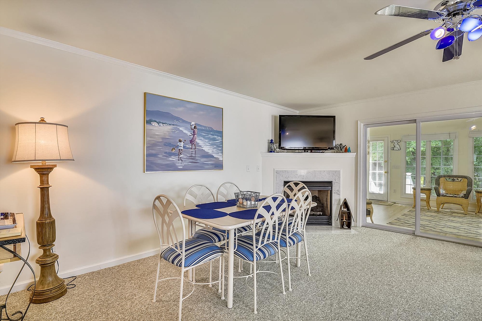 Picture yourself gathering here for meals or games at this inviting dining table, with coastal charm and a fireplace adding warmth to every moment you share together.