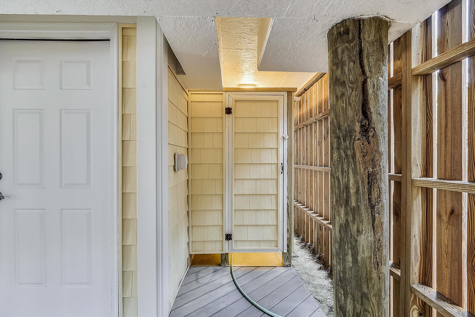 A covered entrance framed by weathered wood and natural stone accents, offering a rustic welcome to the property.
