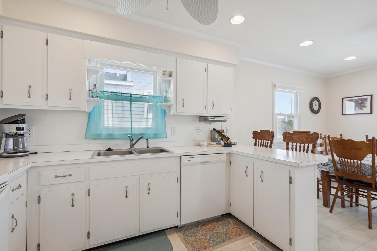 Step into your bright, fully-equipped kitchen with crisp white cabinetry and everything you need to prepare meals during your stay. A welcoming dining table awaits your family gatherings.