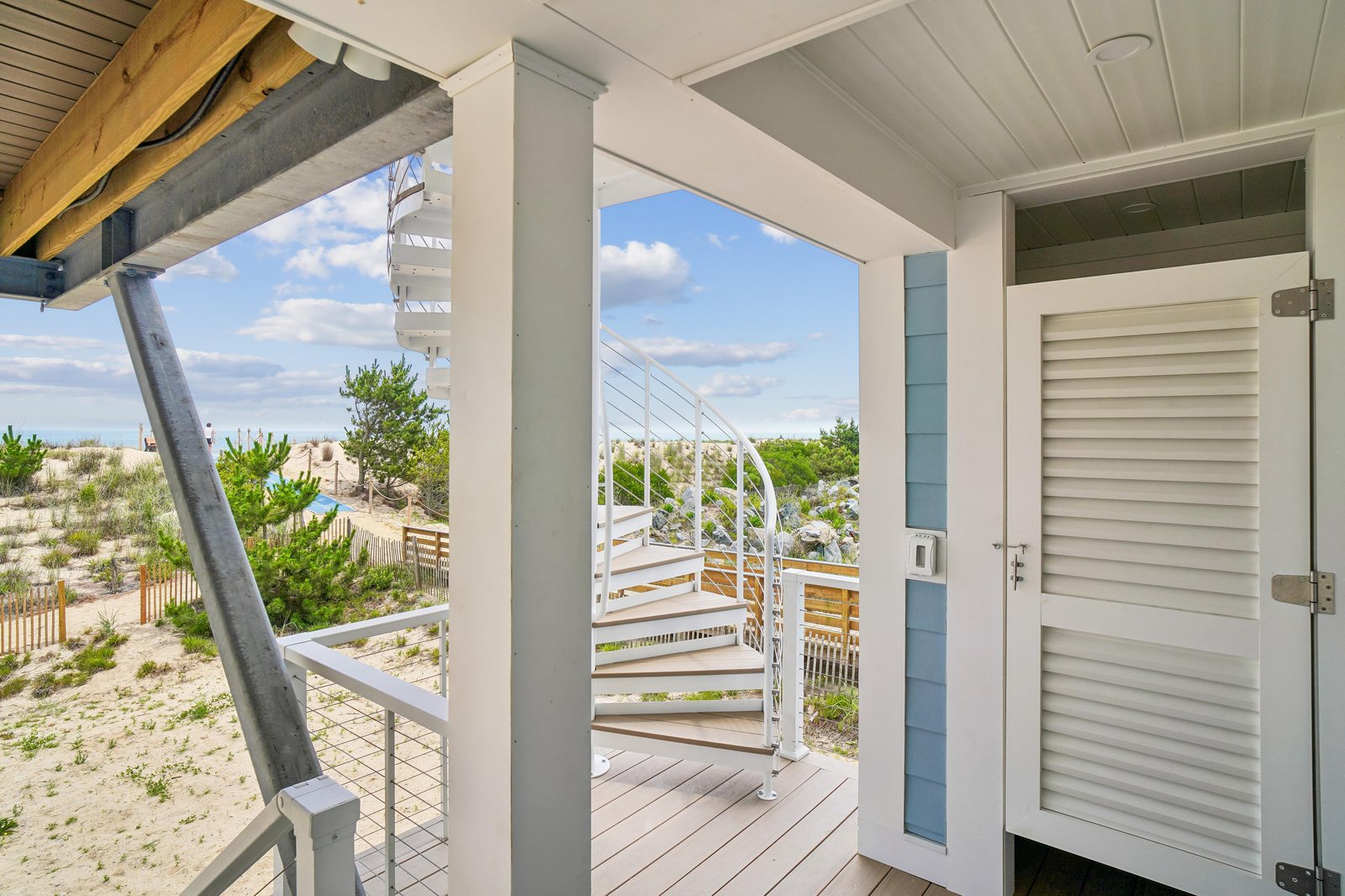 Step onto your private porch and take in the gentle coastal breeze and views of natural dunes and greenery. A perfect spot to start your mornings or unwind with the sound of the ocean nearby.