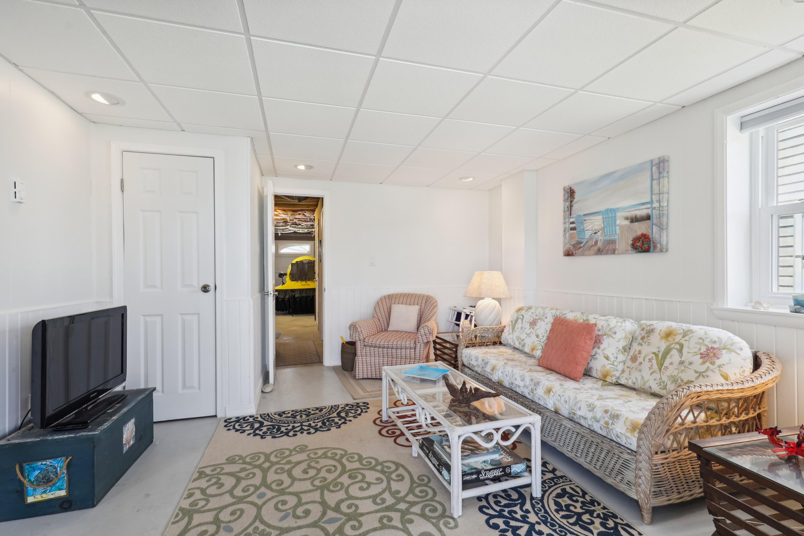 Settle into your cozy private living room, where wicker furnishings and coastal decor invite you to unwind with your favorite show or simply relax after a day at the shore.