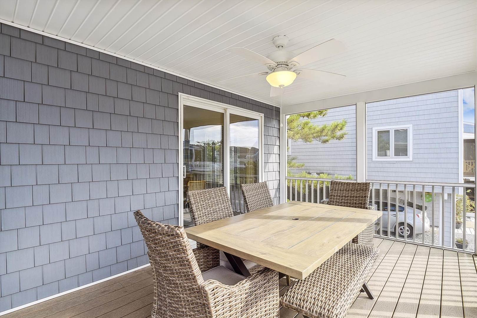 Dine outdoors on your private covered porch with seating for six, complete with a ceiling fan and peek-a-boo water views beyond the trees.