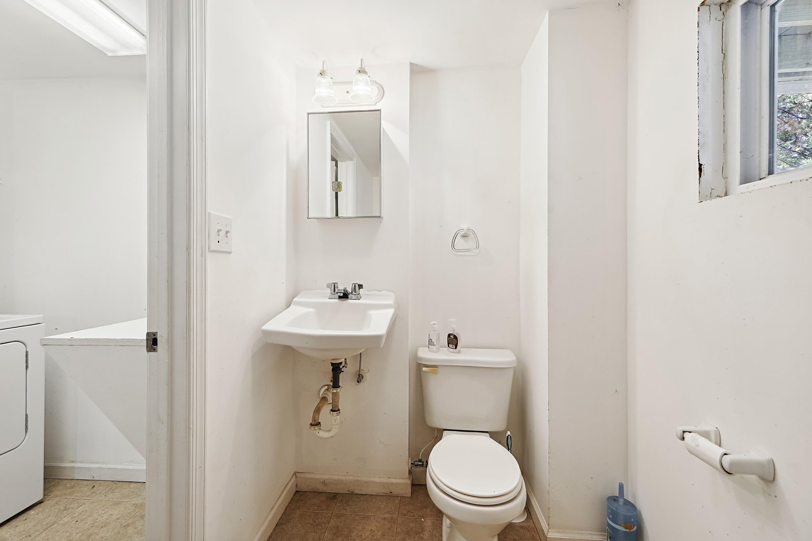 A simple, clean half bath with a pedestal sink and toilet—perfectly functional for your stay.