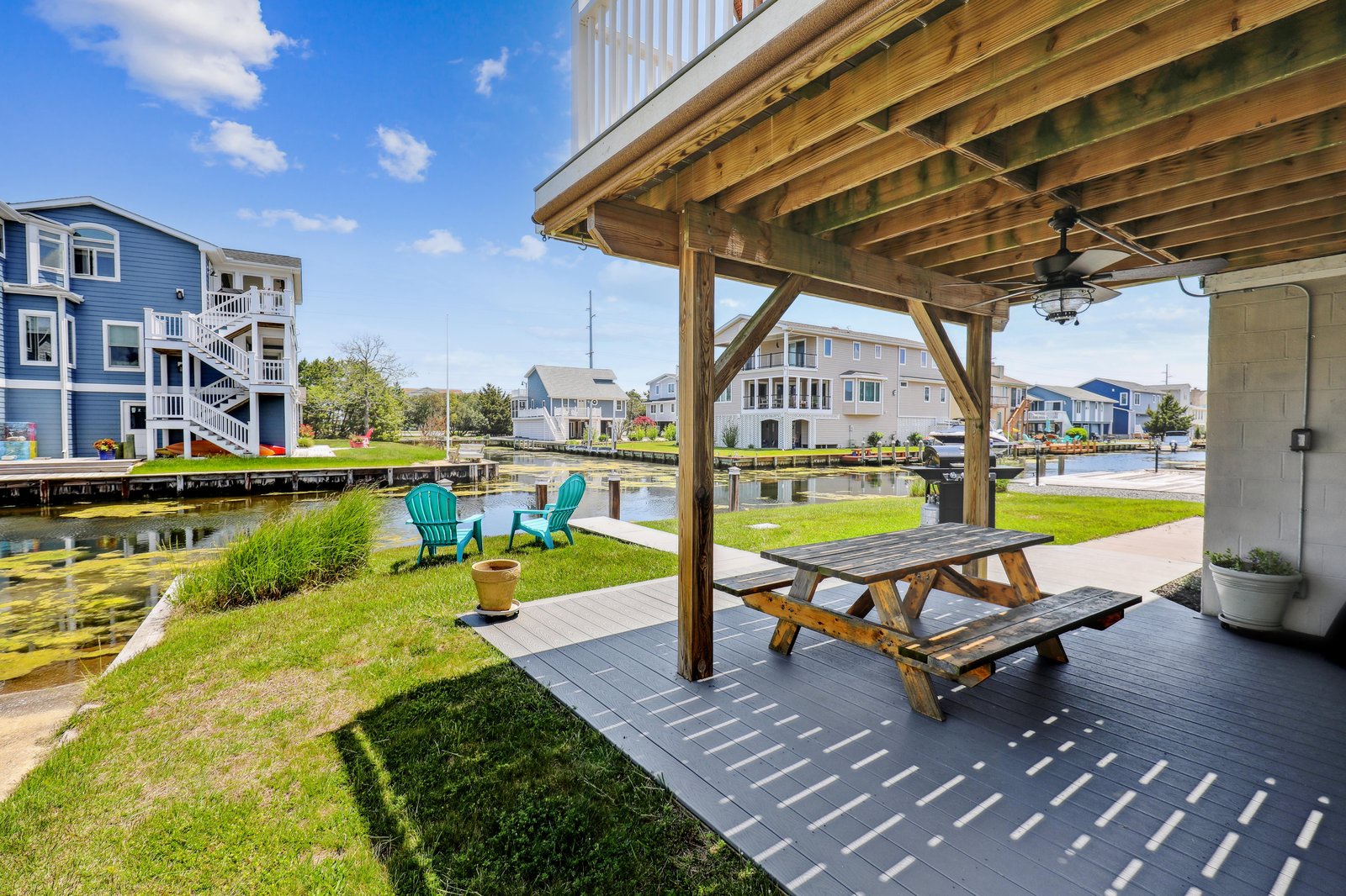 Picture yourself relaxing at your private waterfront patio, complete with a pergola-covered picnic table and Adirondack chairs overlooking the peaceful canal. Perfect for morning coffee or evening gatherings by the water.
