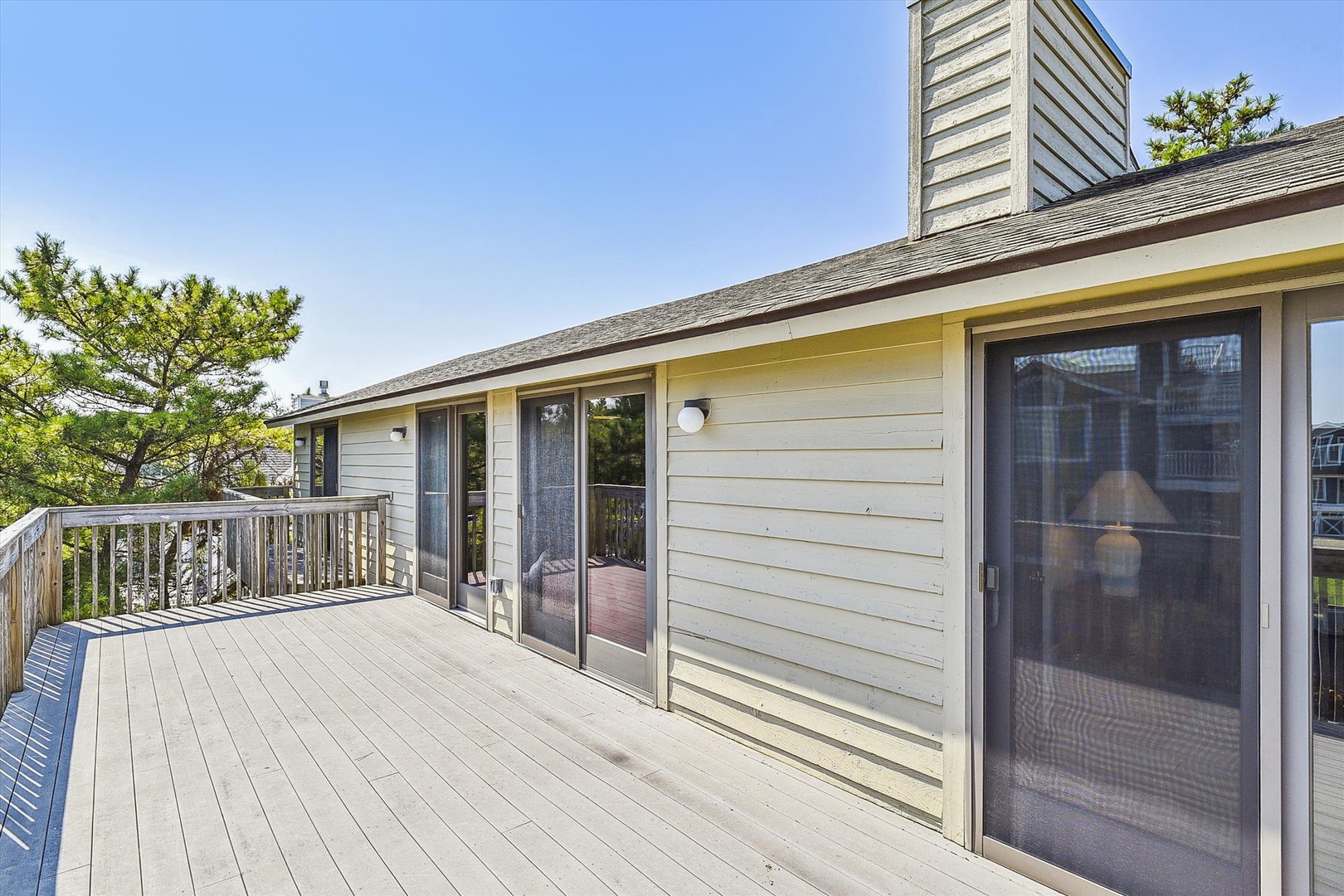 Spacious deck with sliding glass doors connects you to the outdoors, perfect for morning coffee or evening gatherings under the open sky.