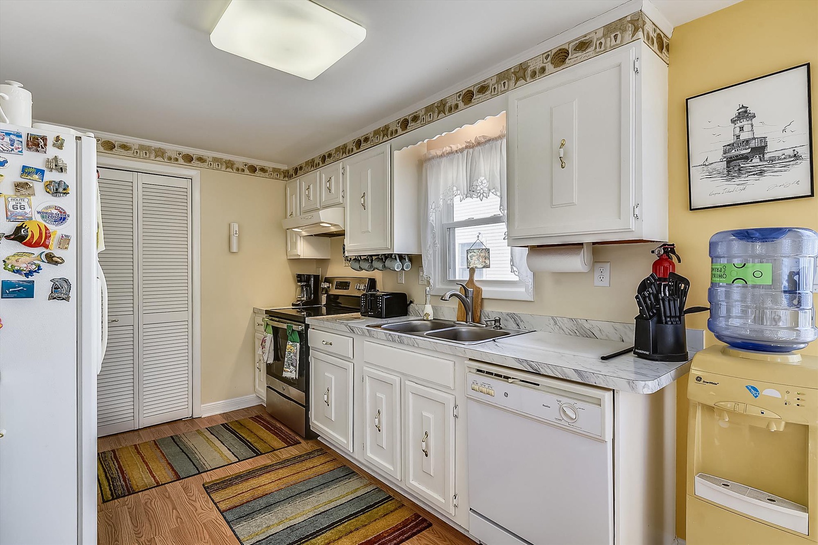 Your fully equipped kitchen features all the appliances you need to cook meals, with bright natural light from the window and ample counter space for food prep.